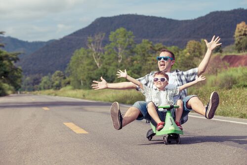 father enjoying road trip with his kid in summer