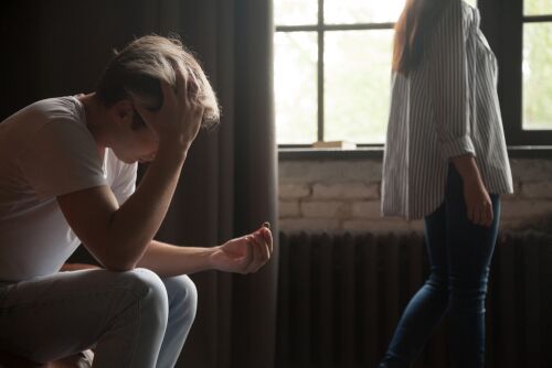 Young frustrated sad man holding wedding engagement ring, wife or girlfriend leaving depressed heartbroken husband, couple breaking up divorce concept, relationships breakup, proposal rejection