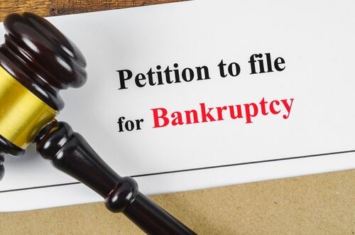 Paper that says "Petition to file for Bankruptcy" with a gavel sitting on it
