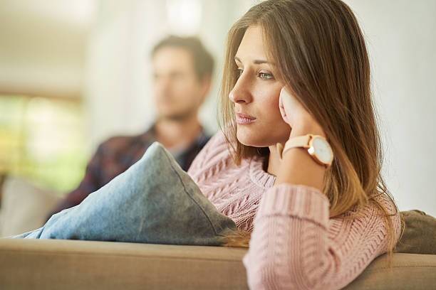 I can't believe we're still fighting about this Shot of an unhappy couple sitting on the couch at home after a fight divorcing couple stock pictures, Does It Matter Who Files for Divorce First in Texas? Expert Insights