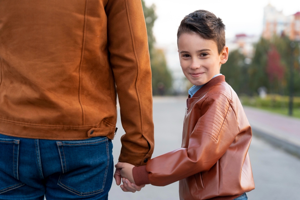 Reasons you need a Revocable Living Trust boy holding hands with his dad