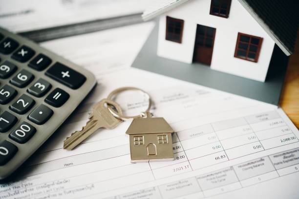 Model of house placed on contract Placed on a wooden table, mortgage and real estate investment, home insurance, security concept.