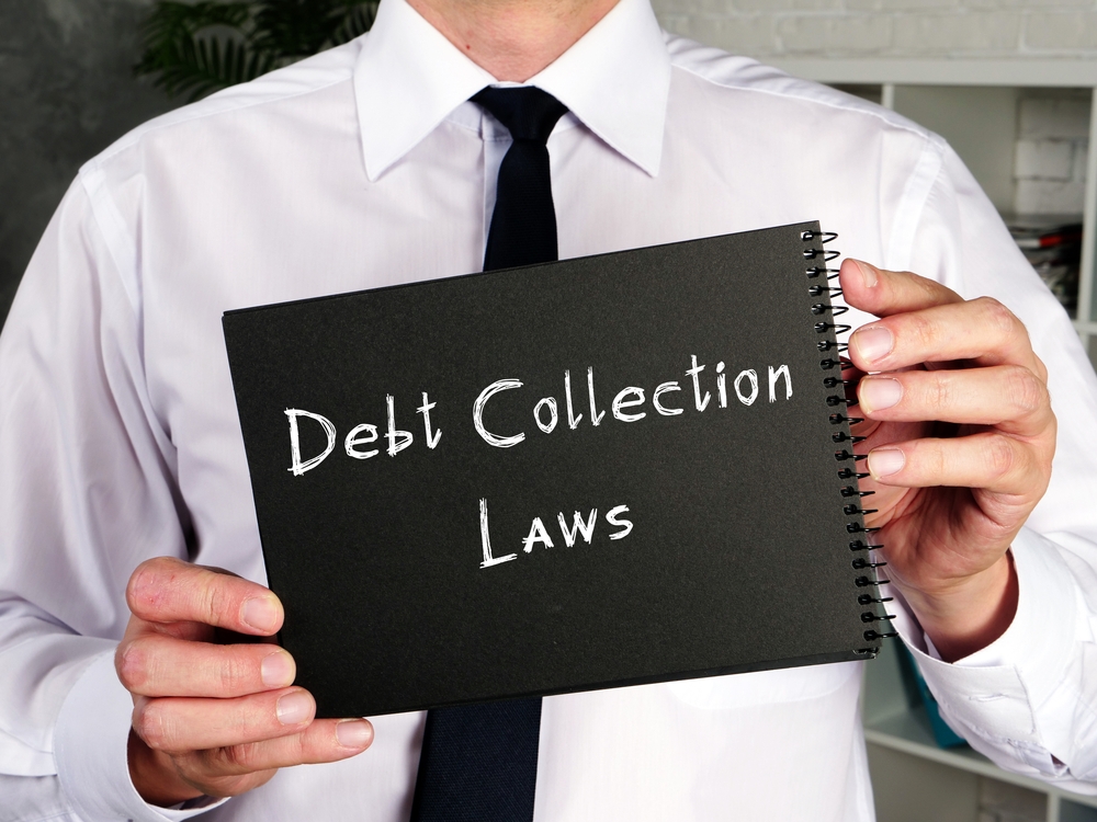 Business concept about Debt Collection Laws with sign on the piece of paper.