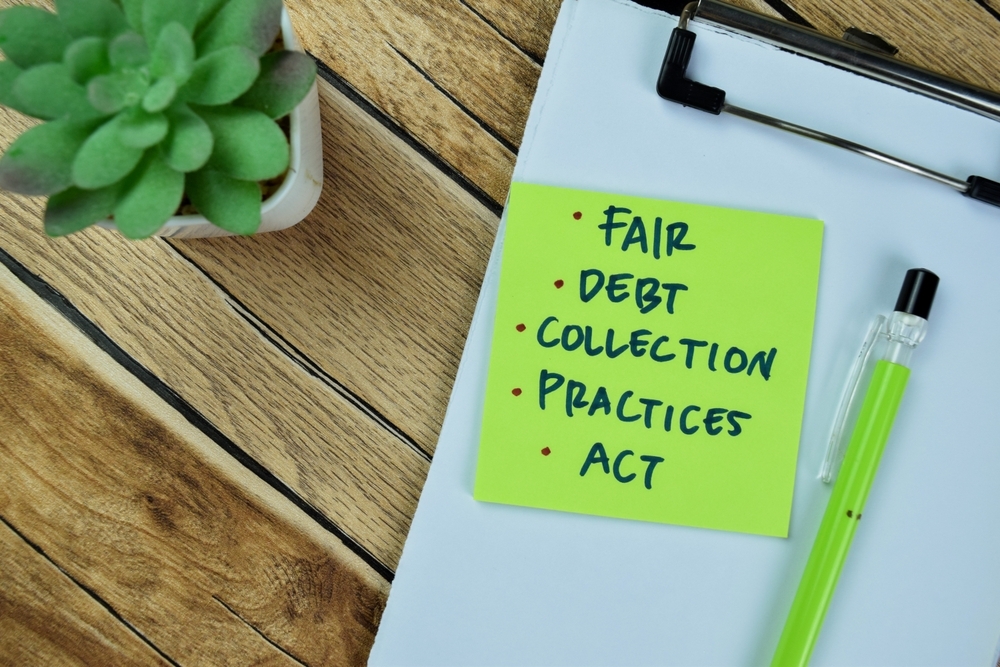 Concept of Fair, Debt, Collection, Practices, Act write on sticky notes isolated on Wooden Table. collection defense lawyer