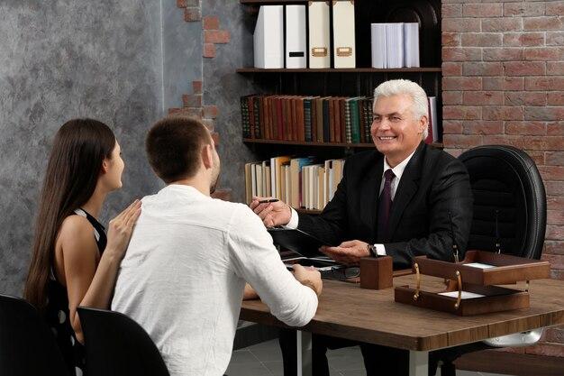 Attorney speaking with a couple in an office setting.