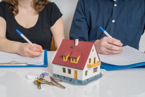 Divorce and dividing a property concept. Man and woman are signing divorce agreement.