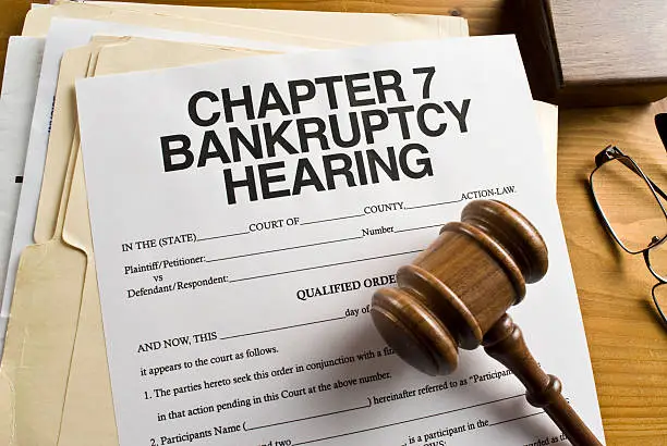 Chapter 7 Bankruptcy hearing paperwork with a gavel sitting on top of it