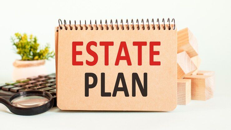 Notepad, flower vase, spectacle, storage card, magnifying glass and words ESTATE PLAN on wooden paper wall. Business and education concept.