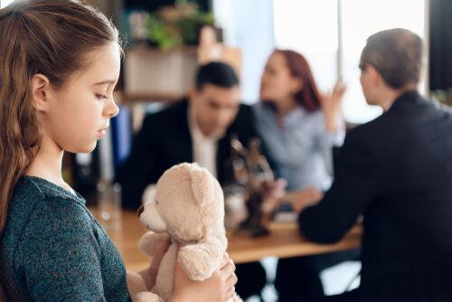 Young couple arranges guardianship of little girl. Registration of guardianship. Family in office of family lawyer. Two parents fighting over child in divorce concept.