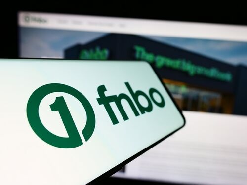 Stuttgart, Germany - 12-28-2023: Smartphone with logo of American financial company First National Bank Omaha (FNBO) in front of website. Focus on center-left of phone display. Unmodified photo.