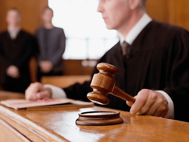 Judge hitting a sound block with a gavel