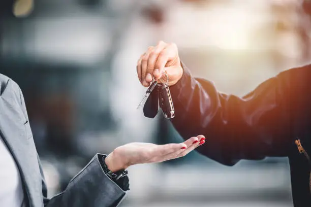 Person about to drop keys in a woman's hand