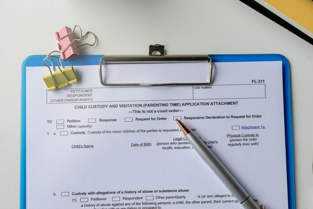 Parental Rights and Custody Arrangements paper in clipboard on office table