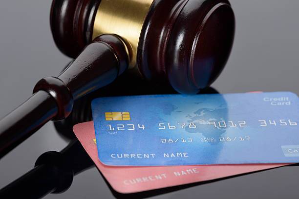 Two credit cards with a gavel next to them