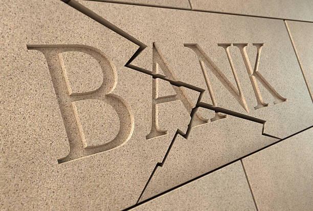 Sandstone 'BANK' sign breaking up with cracks
