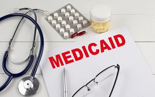 MEDICAID text on a keyboard with stethoscope , medical concept