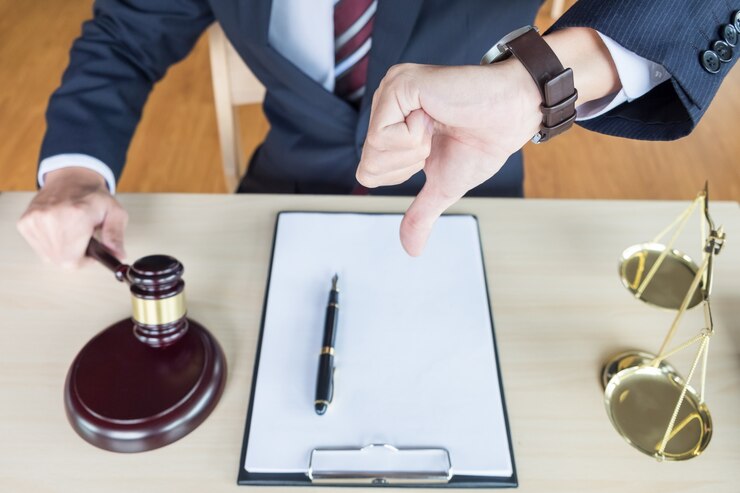 A judge in a suit giving a thumbs down at a desk with a gavel, pen, and clipboard, with scales of justice beside him, indicating denied custody.